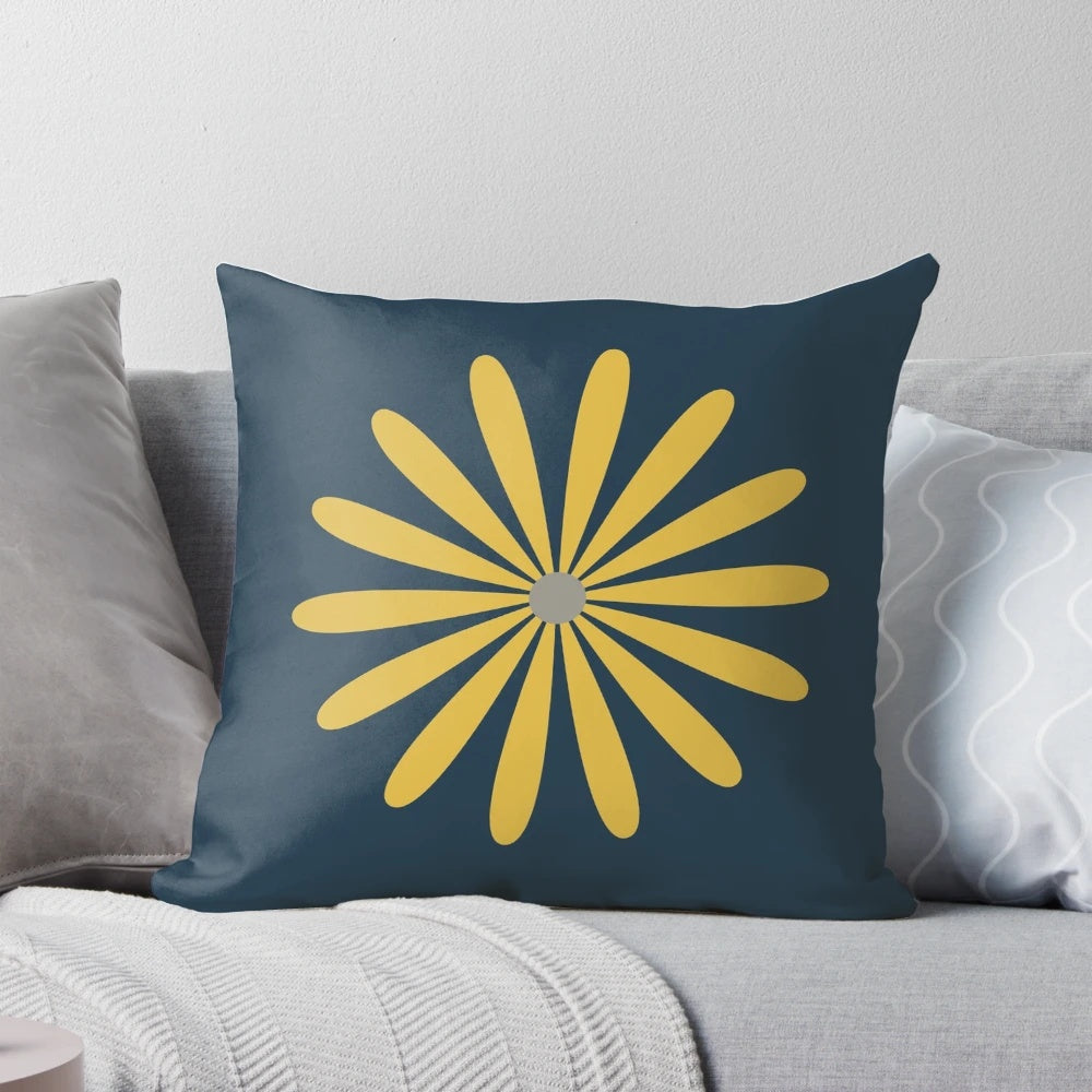 A minimalist, retro-modern navy blue throw pillow with a light mustard and grey daisy floral pattern.