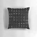 A modern, minimalist throw pillow featuring a white line art design inspired by skateboards.