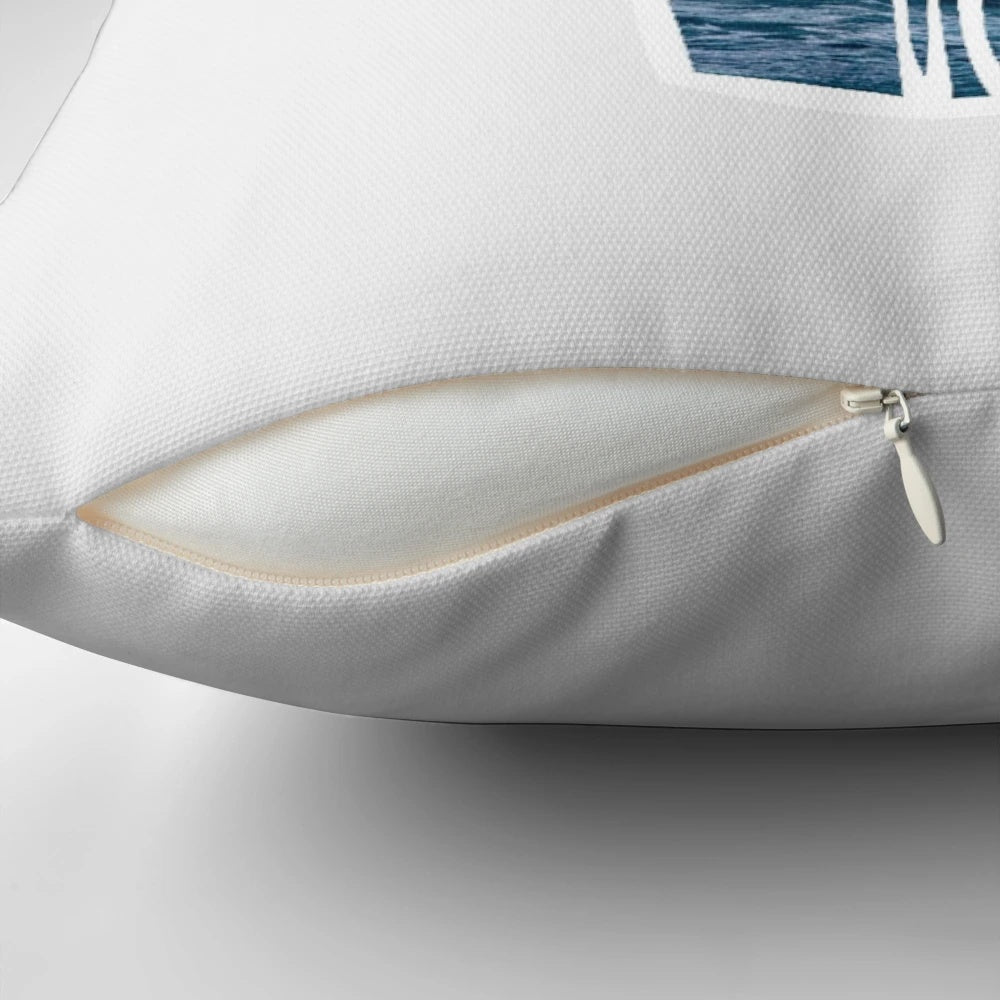 A white pillow with a simple, minimalist design featuring the "hang loose" hand symbol, surrounded by a space and star-filled background.