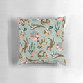 A mint-colored decorative pillow featuring adorable otters swimming in the ocean.