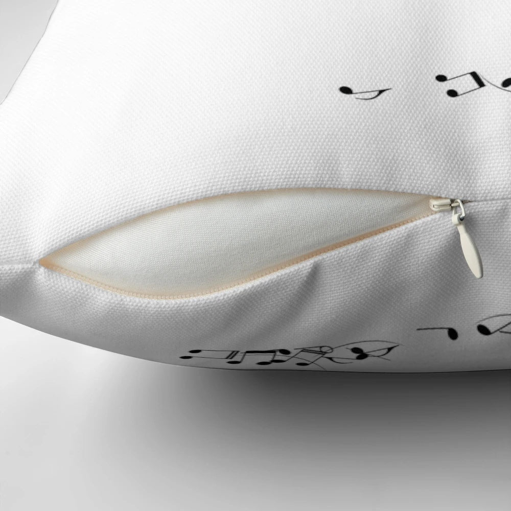 A pillow featuring a whimsical image of a mischievous cat playing with musical sheets and notes.