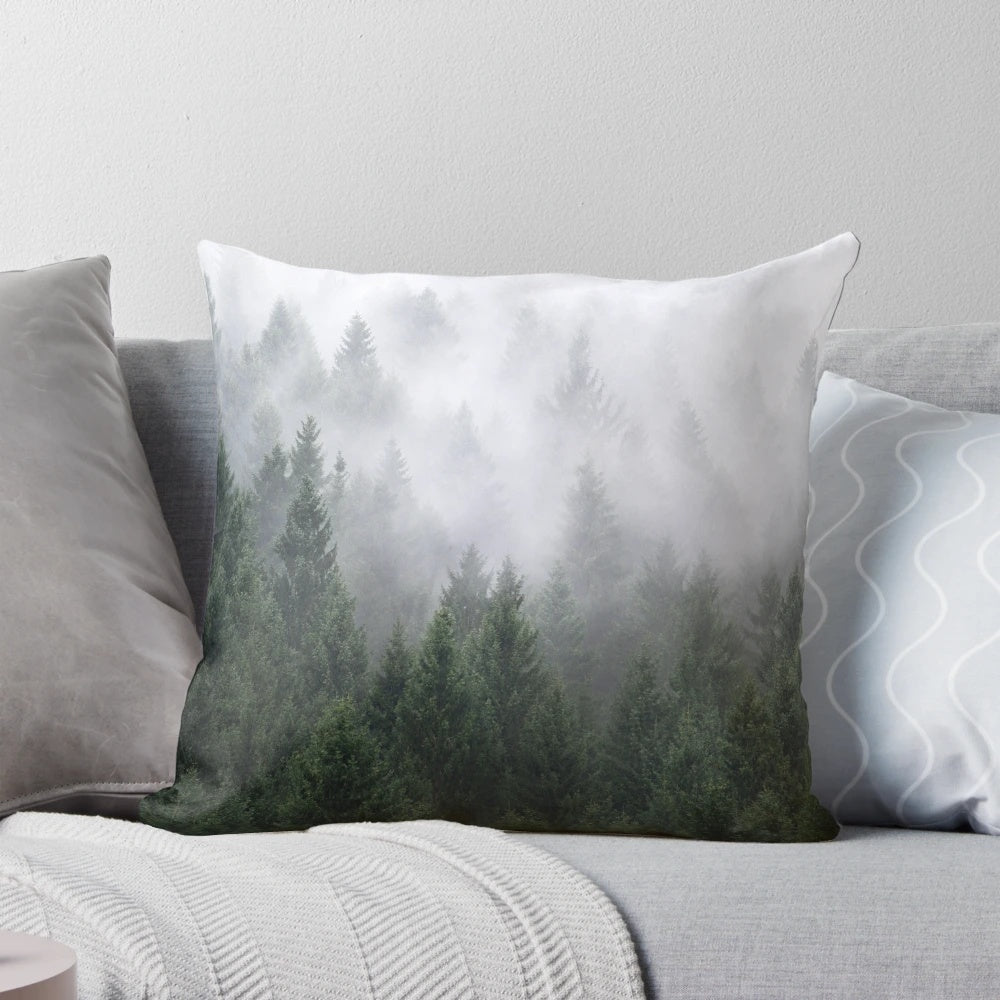A cozy pillow featuring a misty, evergreen forest landscape in a vintage, fairytale style.