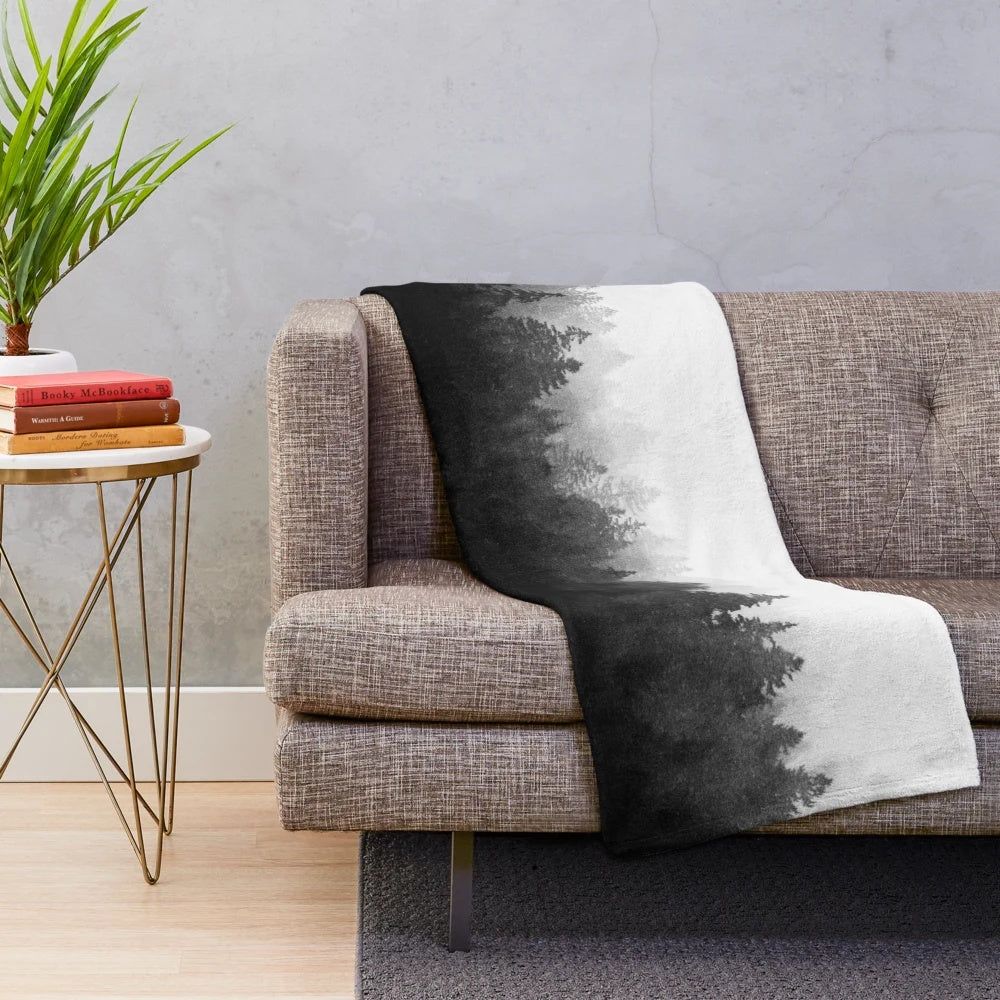 Plush blanket featuring a misty, romantic forest landscape with trees and cascading fog
