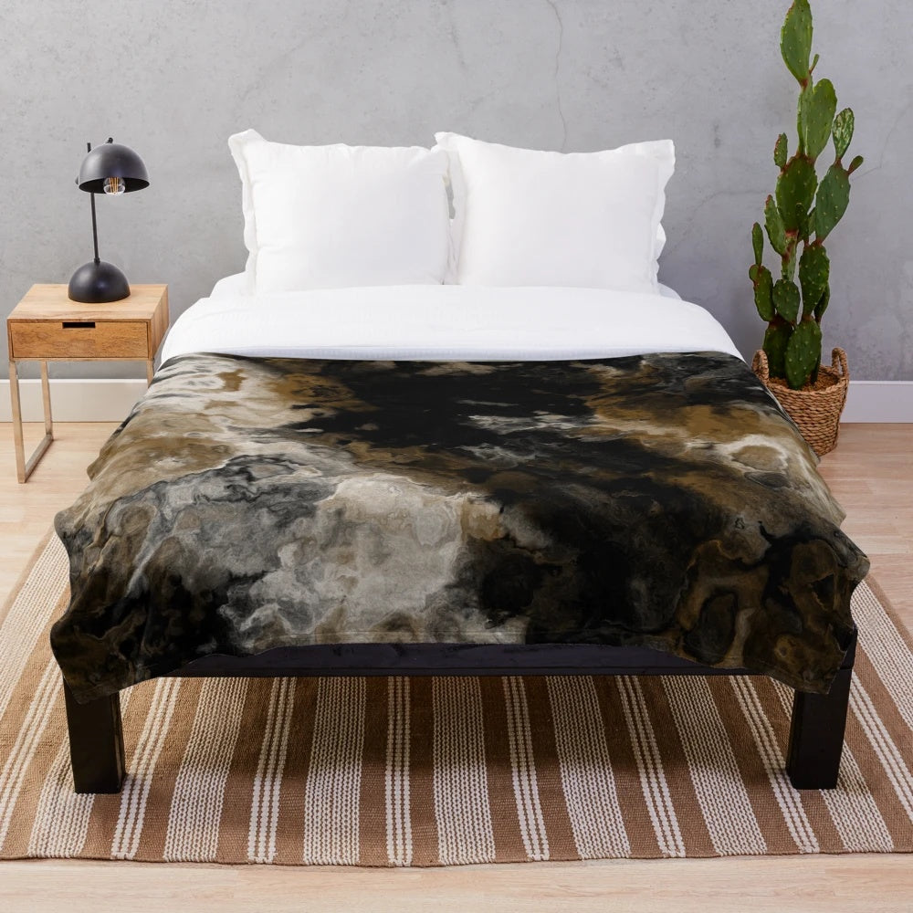 Abstract black and white plush blanket with gold accents