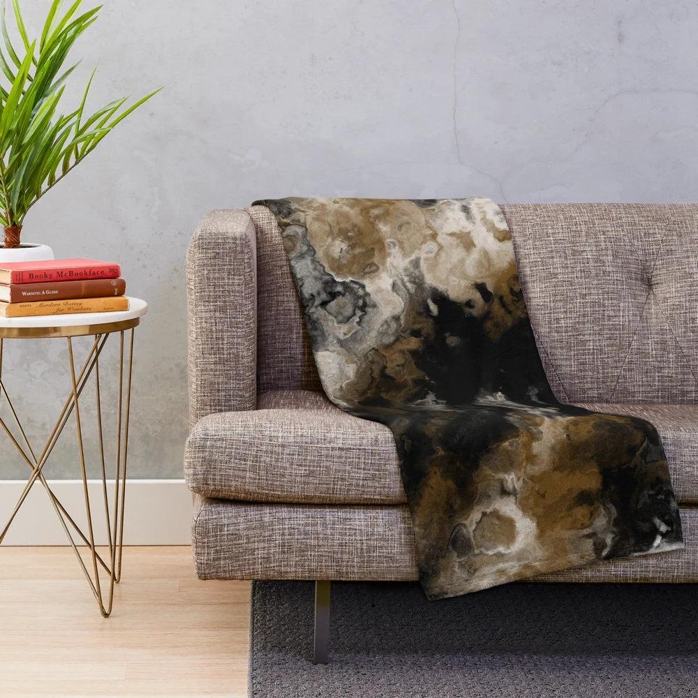 Abstract black and white plush blanket with gold accents