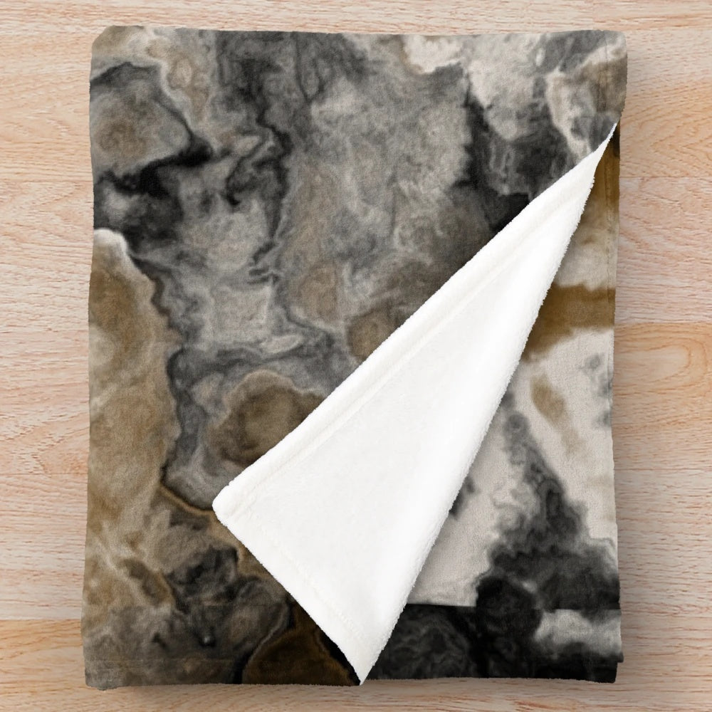 Abstract black and white plush blanket with gold accents