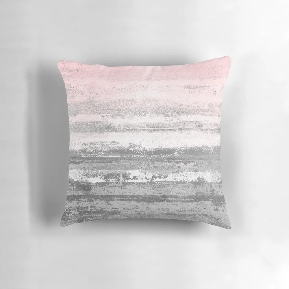 Modern abstract landscape design printed on a soft, plush throw pillow in shades of pink and gray.