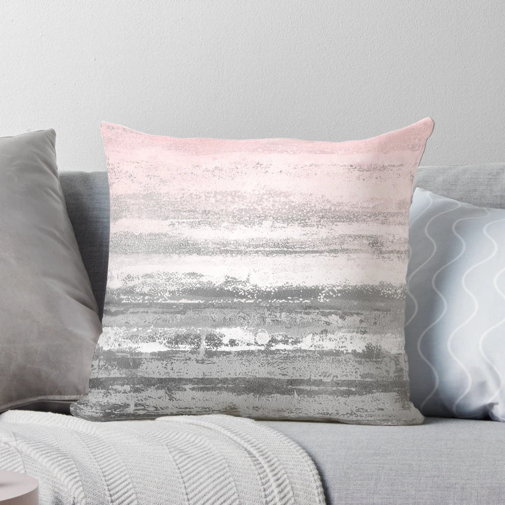 Modern abstract landscape design printed on a soft, plush throw pillow in shades of pink and gray.