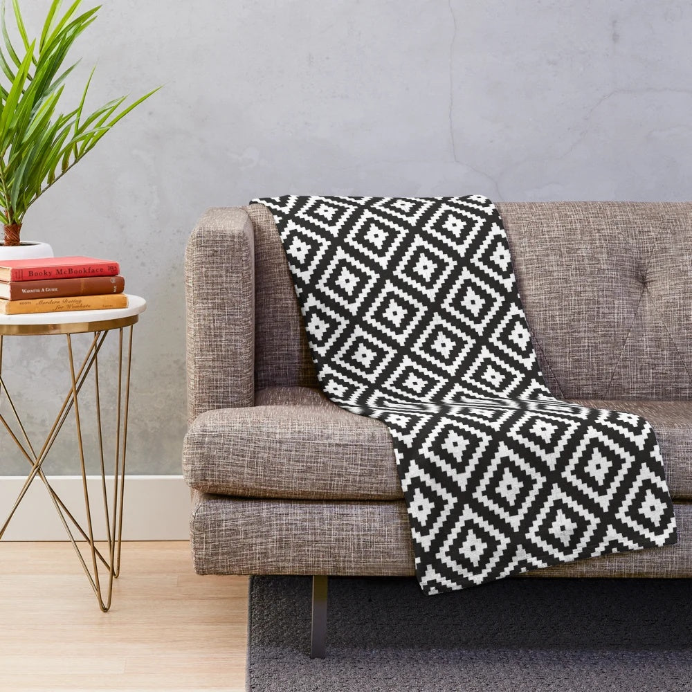 Black and white plush blanket with modern aztec design