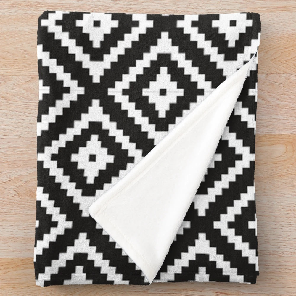 Black and white plush blanket with modern aztec design