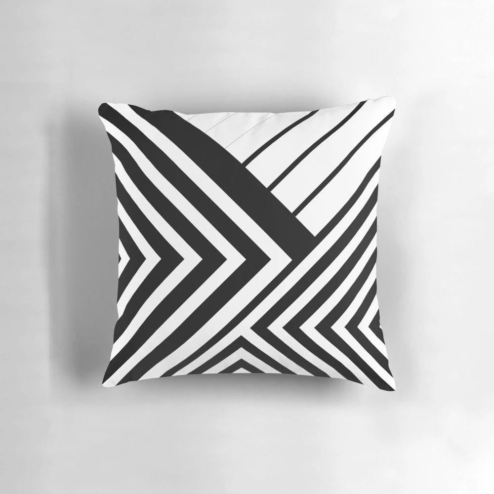 A black and white decorative throw pillow featuring a minimalist geometric line art design.