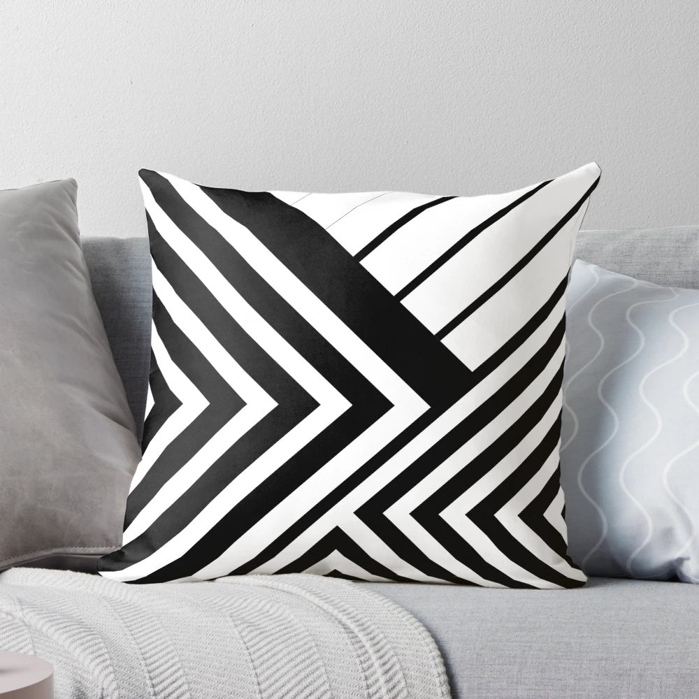 A black and white decorative throw pillow featuring a minimalist geometric line art design.