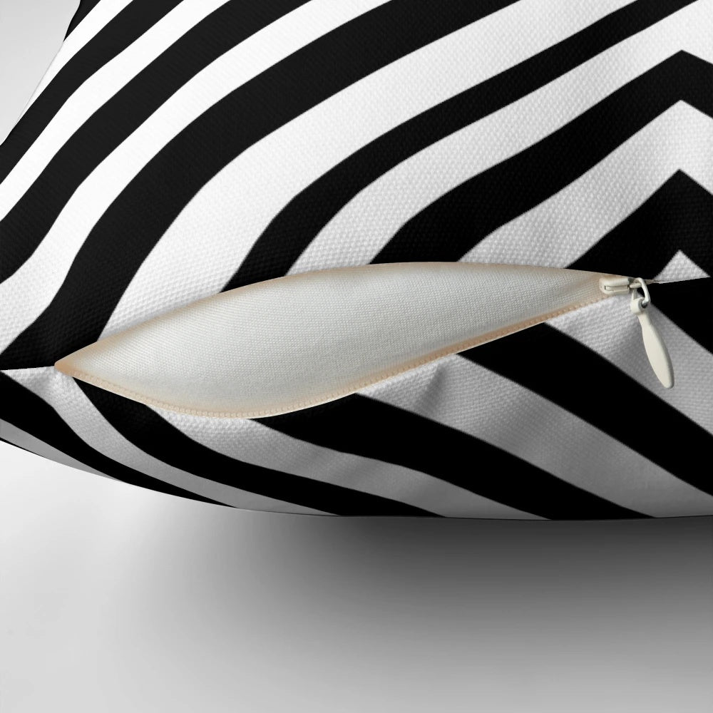 A black and white decorative throw pillow featuring a minimalist geometric line art design.