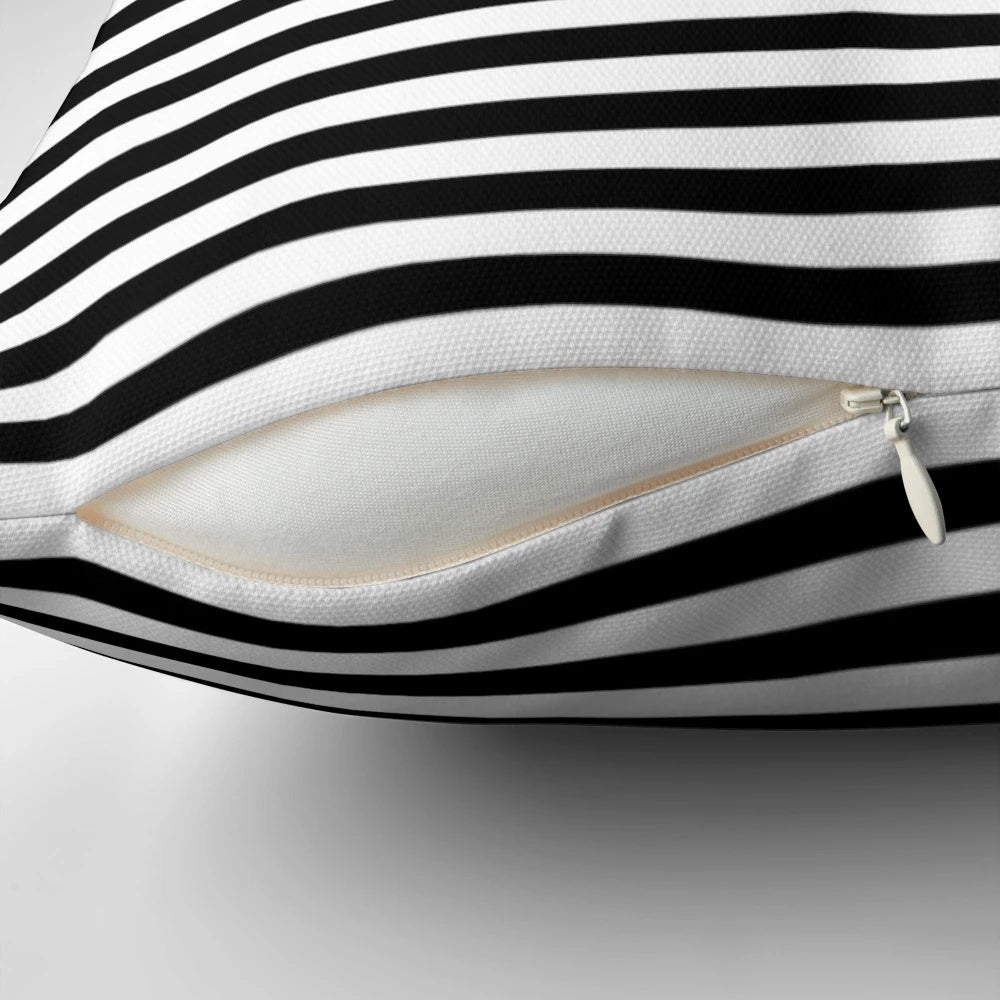 Black and white striped pillow with a modern, minimalist geometric design