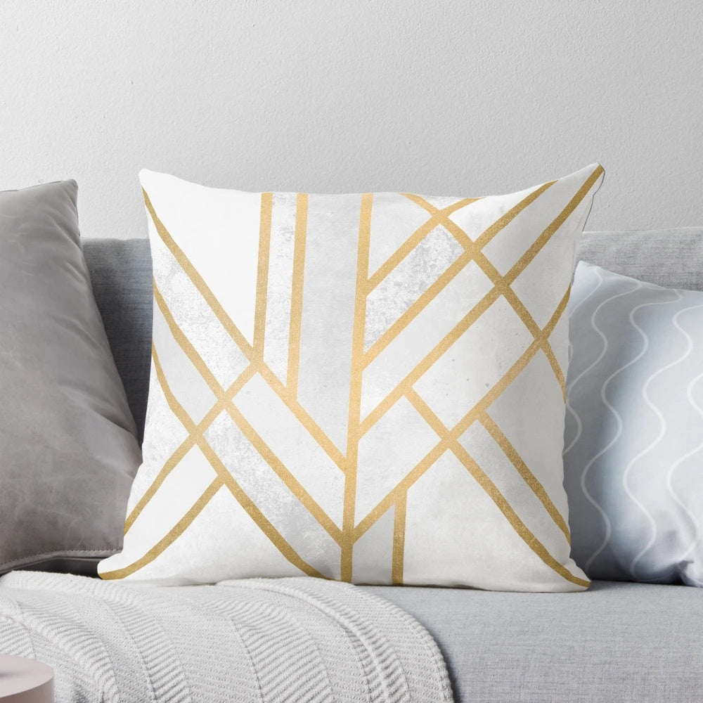 A decorative pillow cover featuring a modern, abstract geometric design in gold and white.
