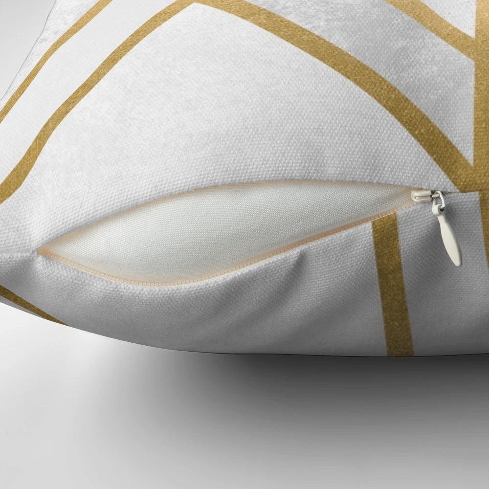 A decorative pillow cover featuring a modern, abstract geometric design in gold and white.