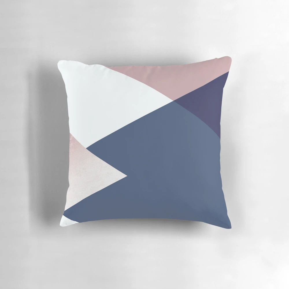 Stylish decorative pillow featuring a geometric isometric pattern in shades of blush, navy, and rose gold