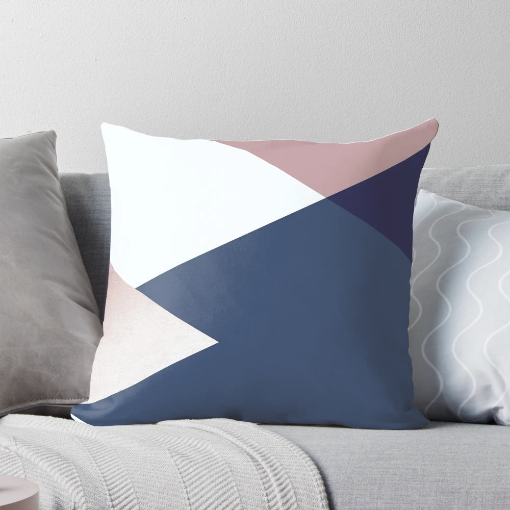 Stylish decorative pillow featuring a geometric isometric pattern in shades of blush, navy, and rose gold