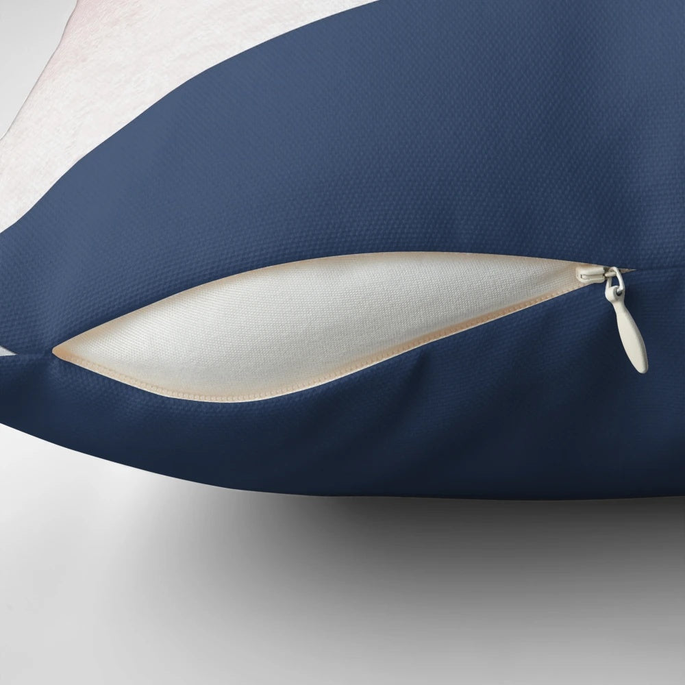 Stylish decorative pillow featuring a geometric isometric pattern in shades of blush, navy, and rose gold