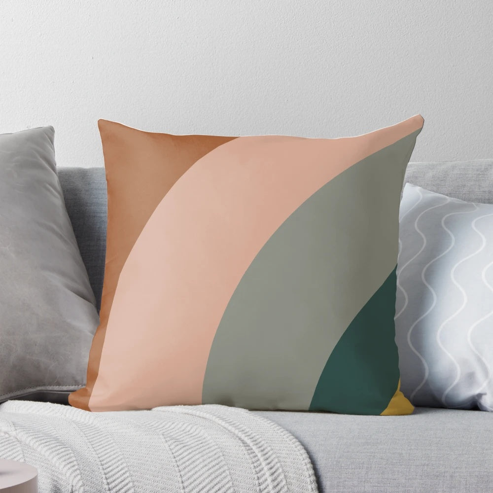 Minimalist pillow featuring an abstract pattern in shades of teal, grey, blush pink, and rust.