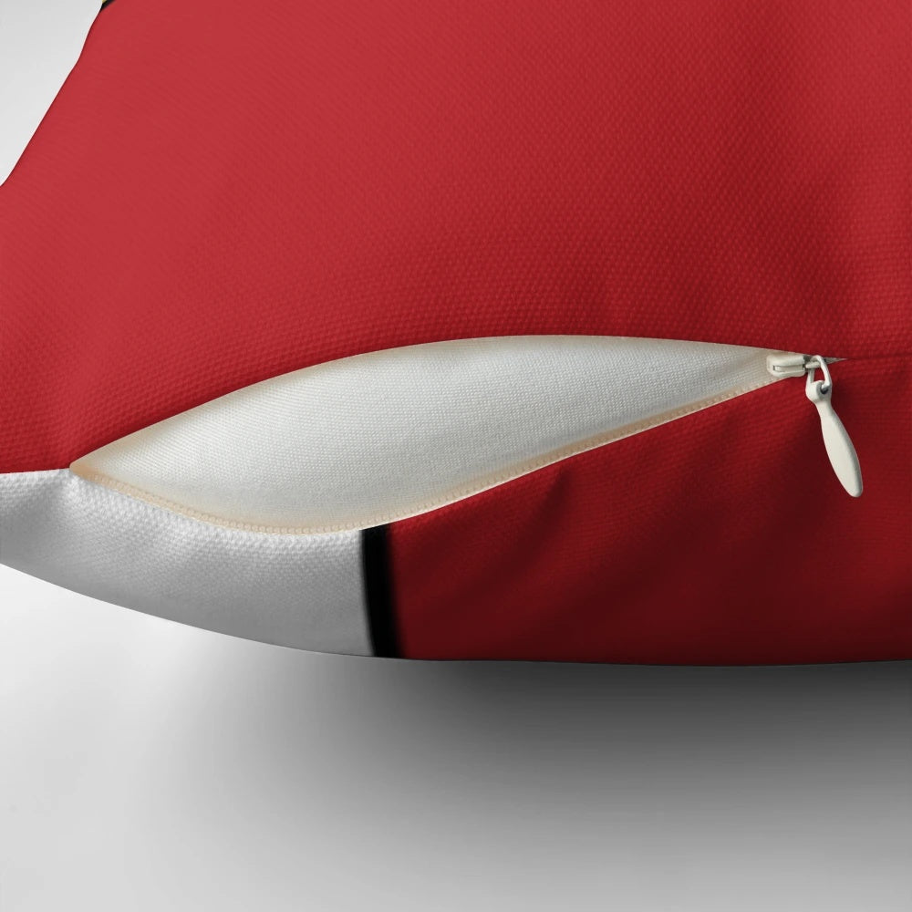 A modern, geometric pillow featuring a Piet Mondrian-inspired polychromatic design with a cat silhouette.