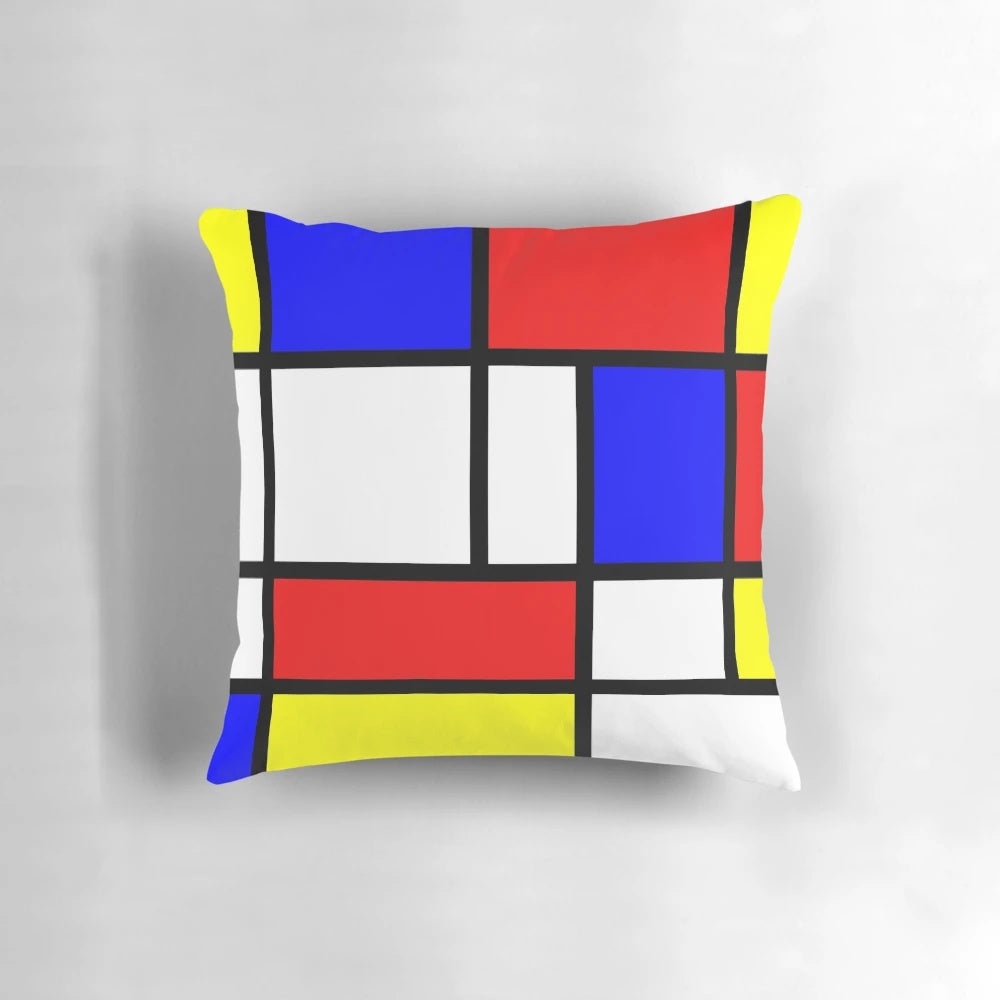 Vibrant red, blue, yellow, and white abstract art pillow with a Mondrian-inspired color block design