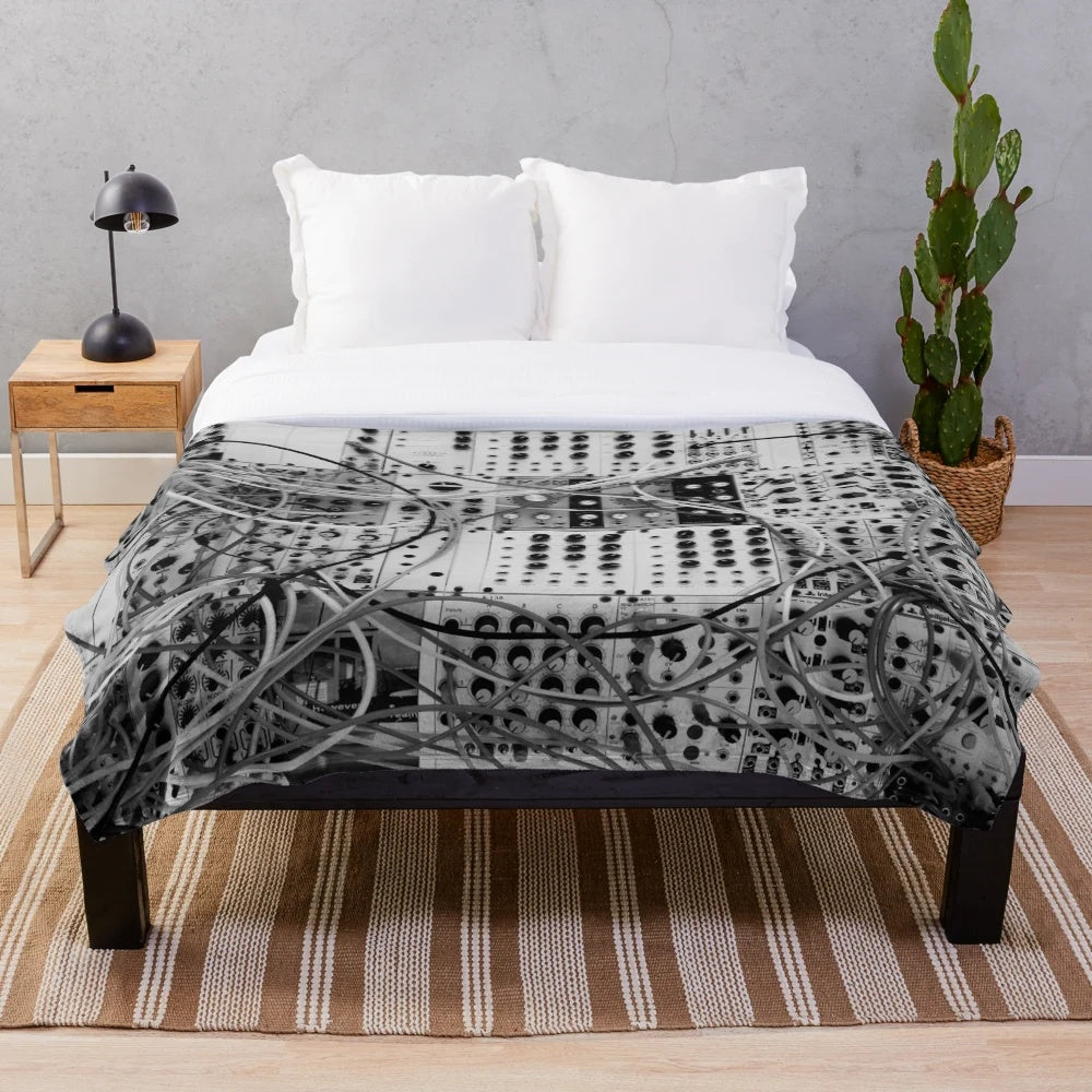 Plush blanket with analog synthesizer inspired modular design in black and white
