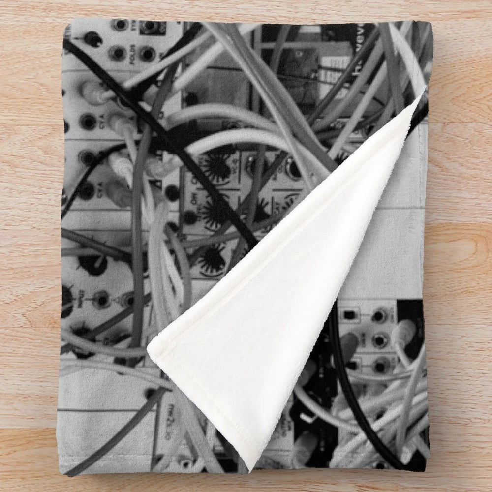 Plush blanket with analog synthesizer inspired modular design in black and white