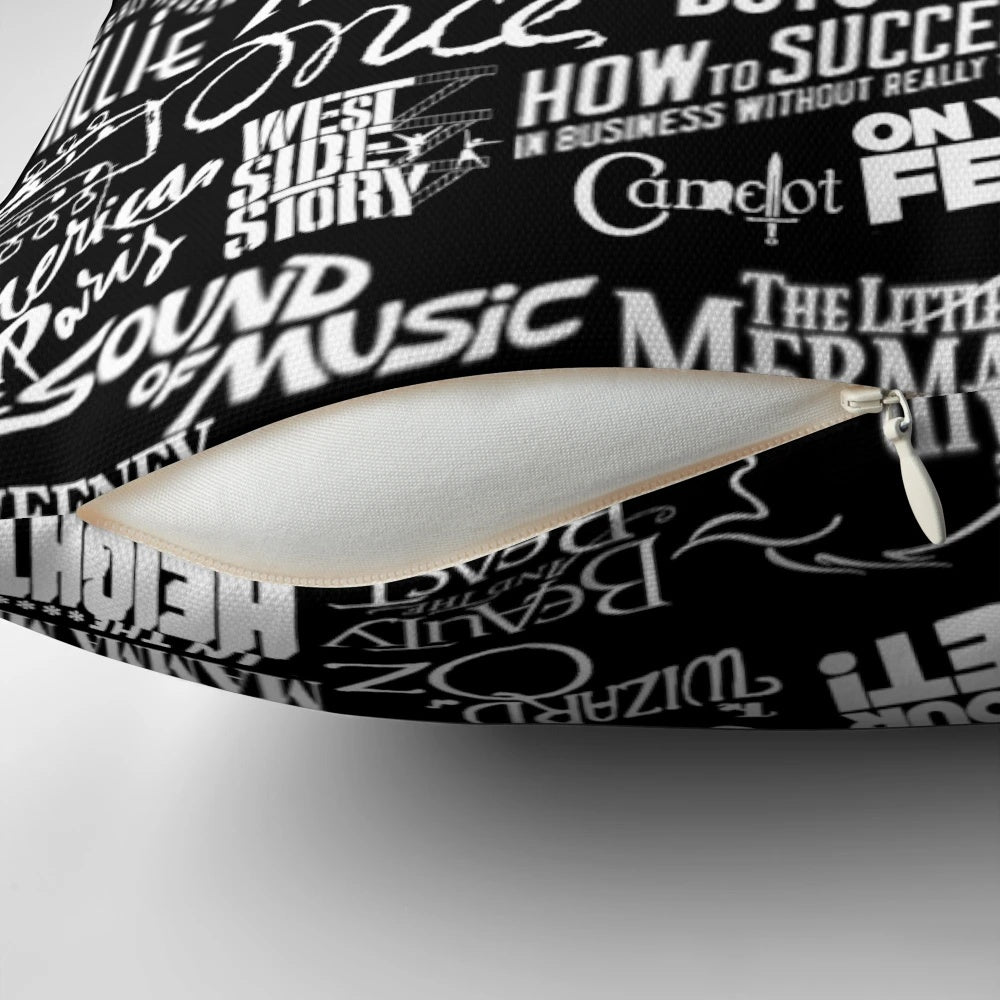 Black and white pillow with a broadway-themed design