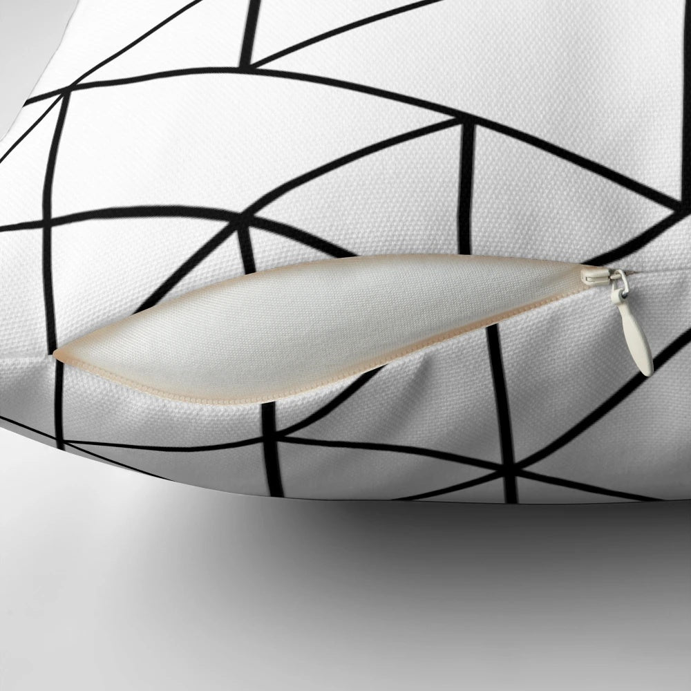 Black and white pillow with abstract triangular pattern, ideal for minimalist and Scandinavian-inspired home decor.