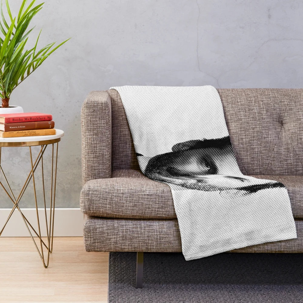 A stylized black and white portrait of actor Jon Hamm printed on a soft, plush blanket