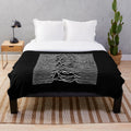 Monochrome plush blanket with 'Unknown Pleasures' album cover-inspired design