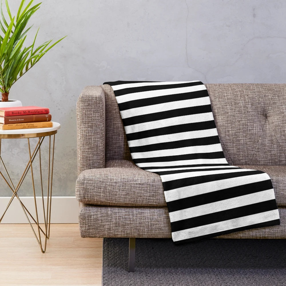 Black and white plush blanket with vertical stripes