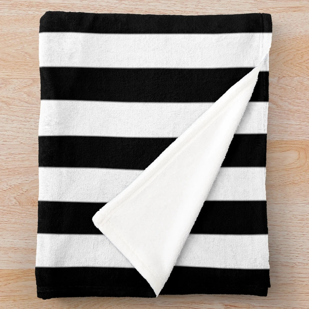 Black and white plush blanket with vertical stripes