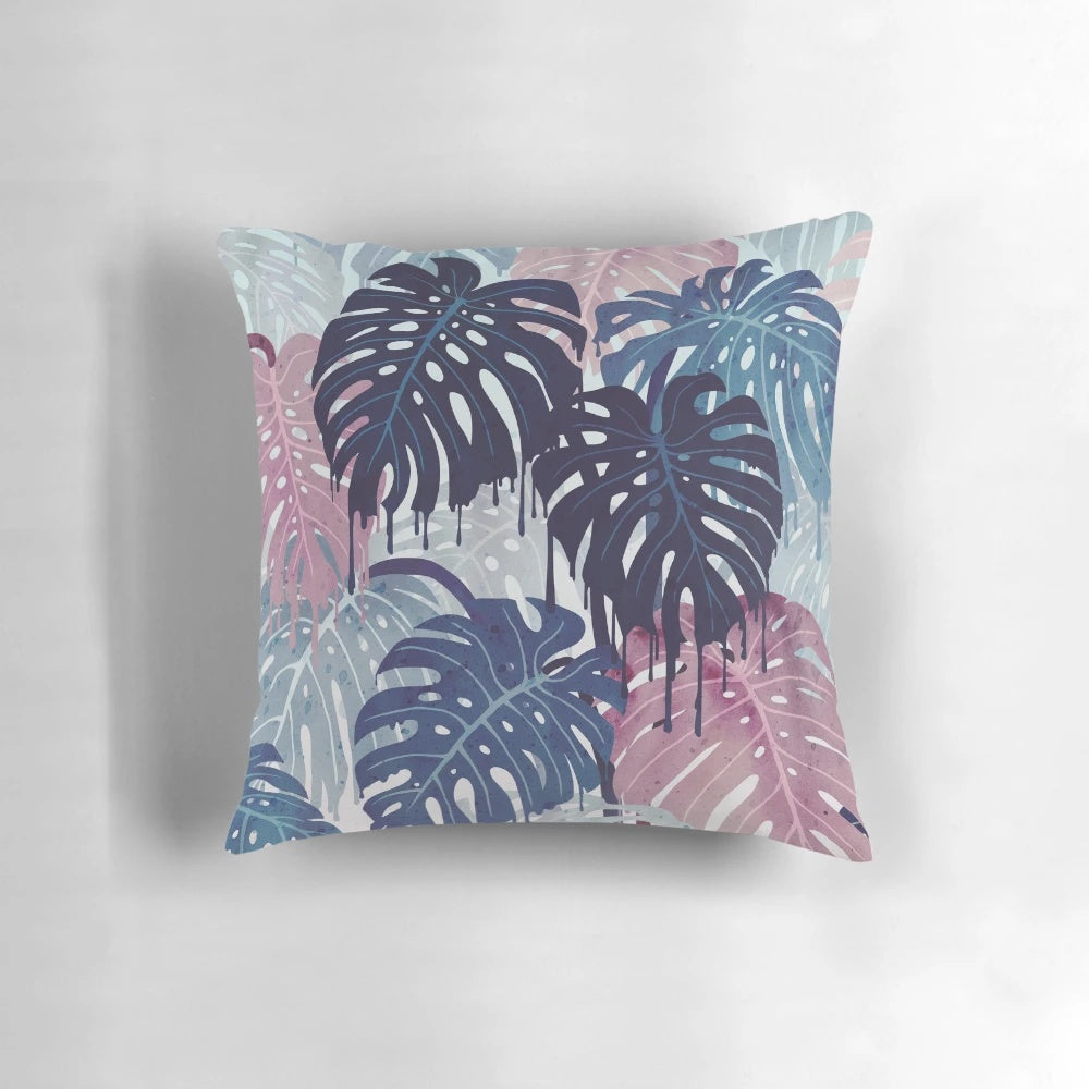 A vibrant, surreal-looking pillow with a monstera leaf design, featuring a blend of blue, pink, and green hues that evoke a tropical, rainy forest atmosphere.