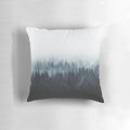 A dark and moody pillow featuring a watercolor-style illustration of a foggy forest with Cascadia trees.
