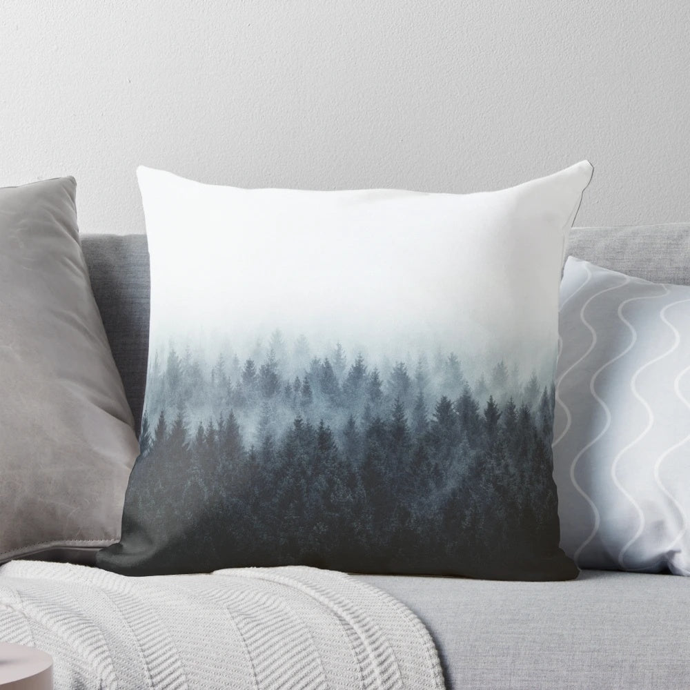 A dark and moody pillow featuring a watercolor-style illustration of a foggy forest with Cascadia trees.