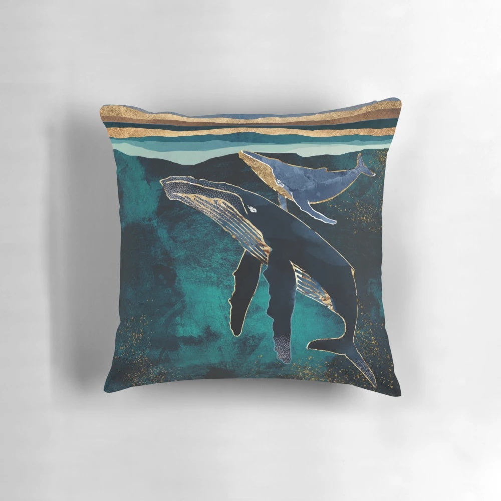 Moonlit whales floating in a serene, abstract underwater landscape on a decorative pillow.