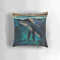 Moonlit whales floating in a serene, abstract underwater landscape on a decorative pillow.