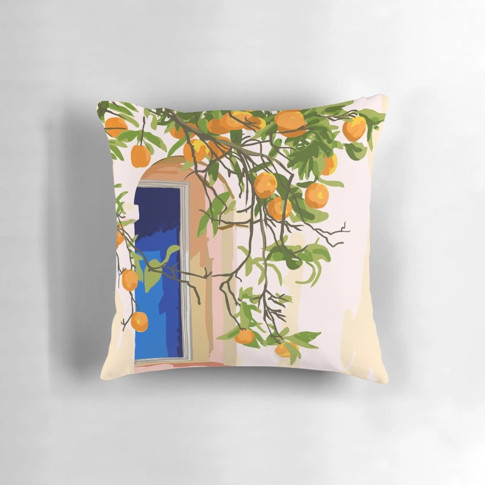 A vibrant, boho-style decorative pillow featuring an architectural building and orange botanical patterns, perfect for a Moroccan-inspired or travel-themed home.