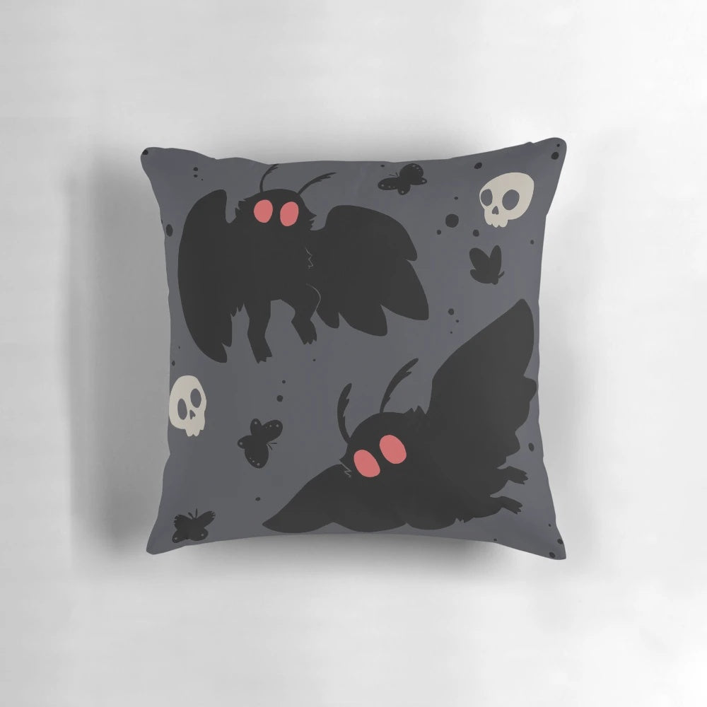 Soft, grey Mothman pillow with a cute, fluffy design and subtle skull motif.