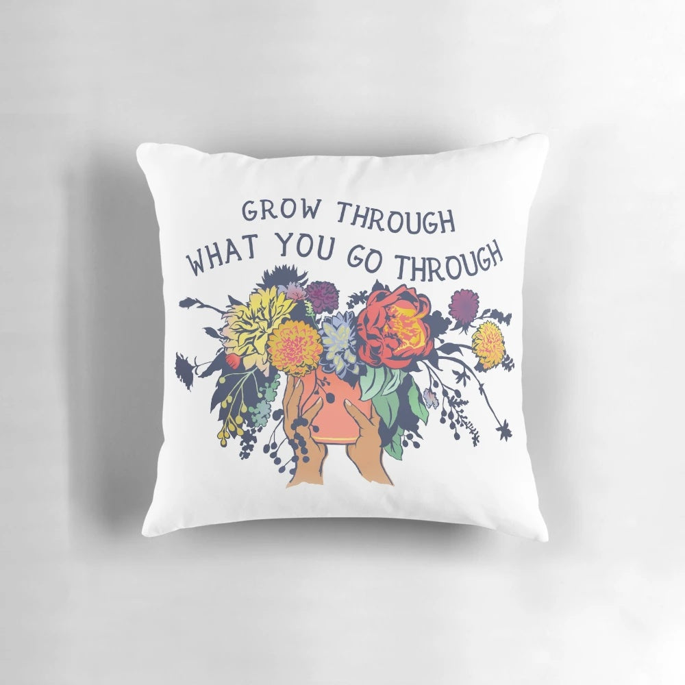 Pillow with the text "Grow Through What You Go Through" and a bouquet of flowers