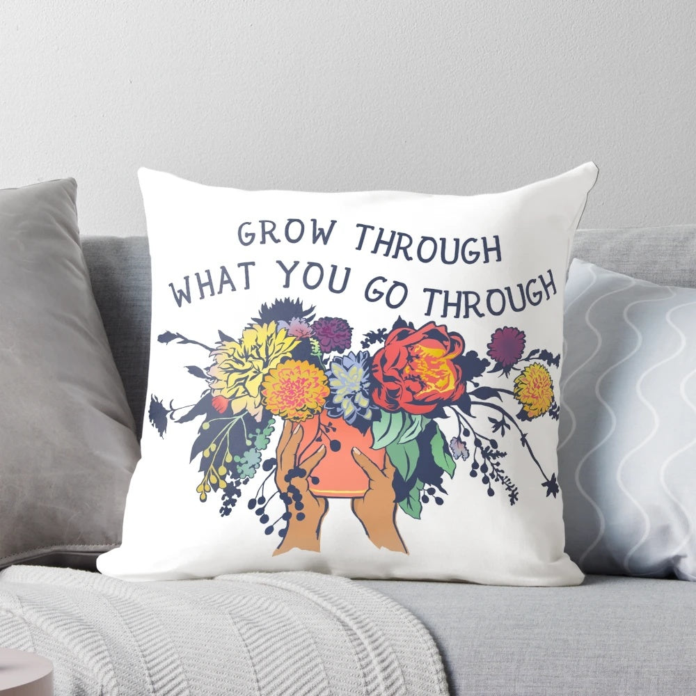 Pillow with the text "Grow Through What You Go Through" and a bouquet of flowers