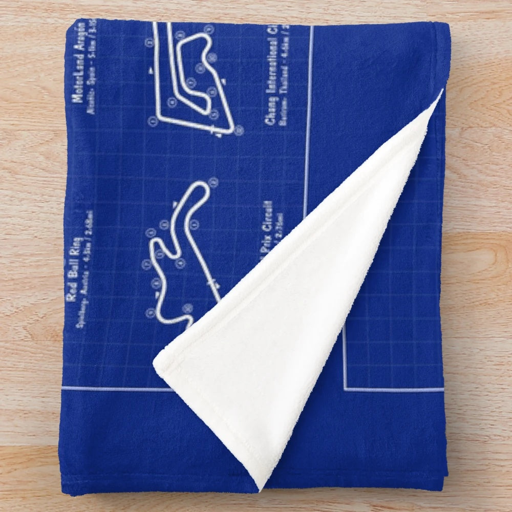Motorsports inspired plush blanket featuring a blueprint design of a MotoGP race track