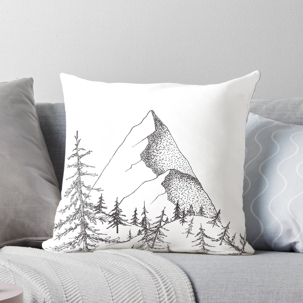 Mountain pillow featuring a landscape of pine trees and a majestic mountain range