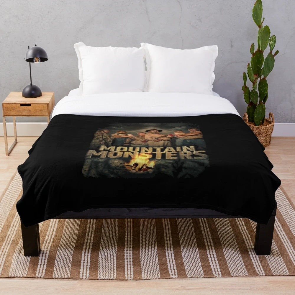 Plush blanket featuring various cryptid and supernatural creature designs including bigfoot, werewolf, and lizard man
