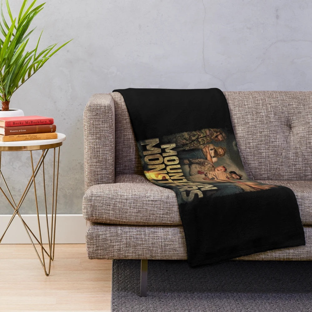 Plush blanket featuring various cryptid and supernatural creature designs including bigfoot, werewolf, and lizard man