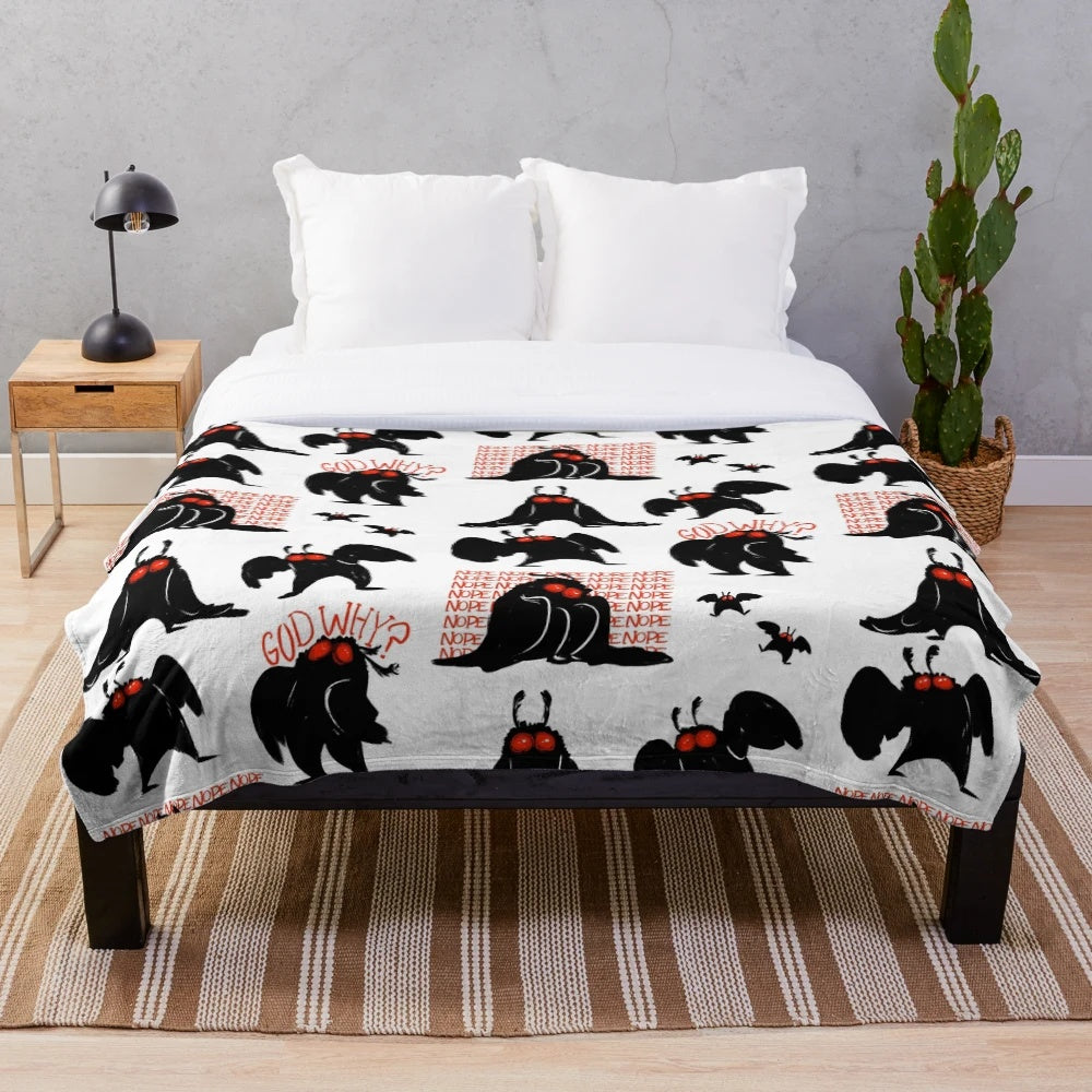 Mothman-inspired plush blanket in black, white, and red