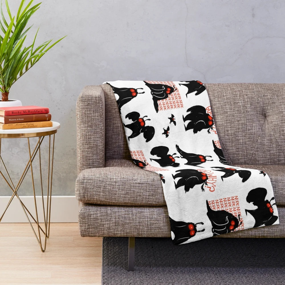 Mothman-inspired plush blanket in black, white, and red