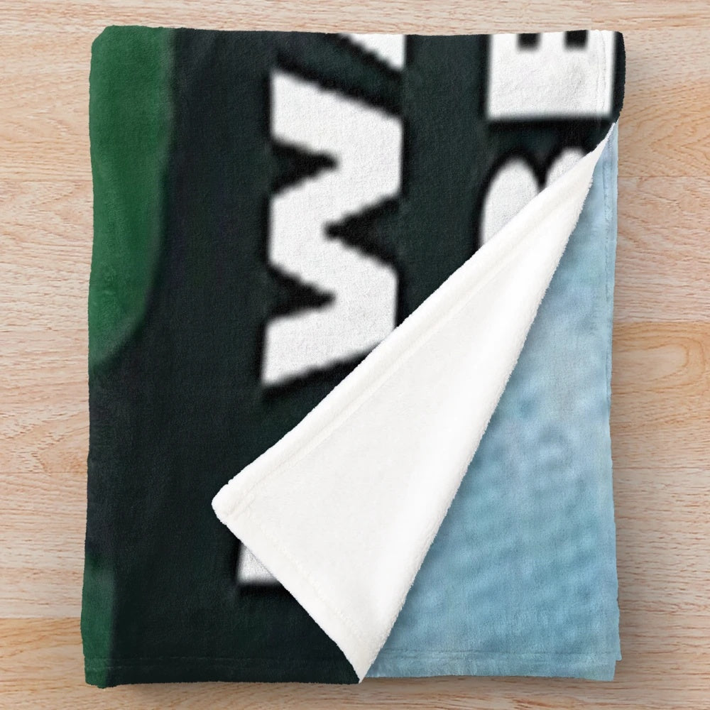 X-Files inspired plush blanket with UFO and alien graphic